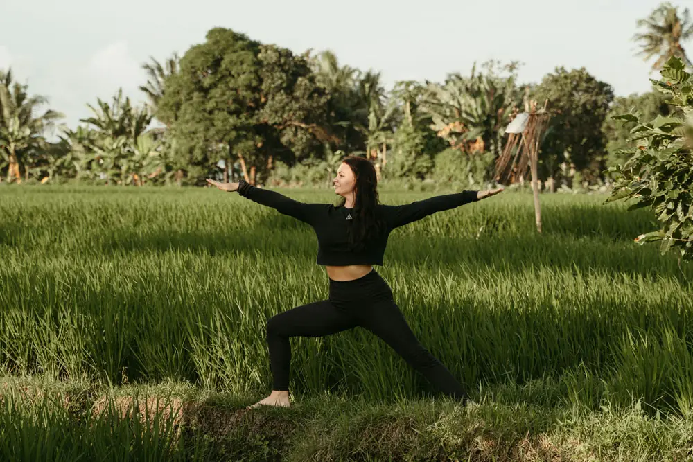 Woman stretching in a green field