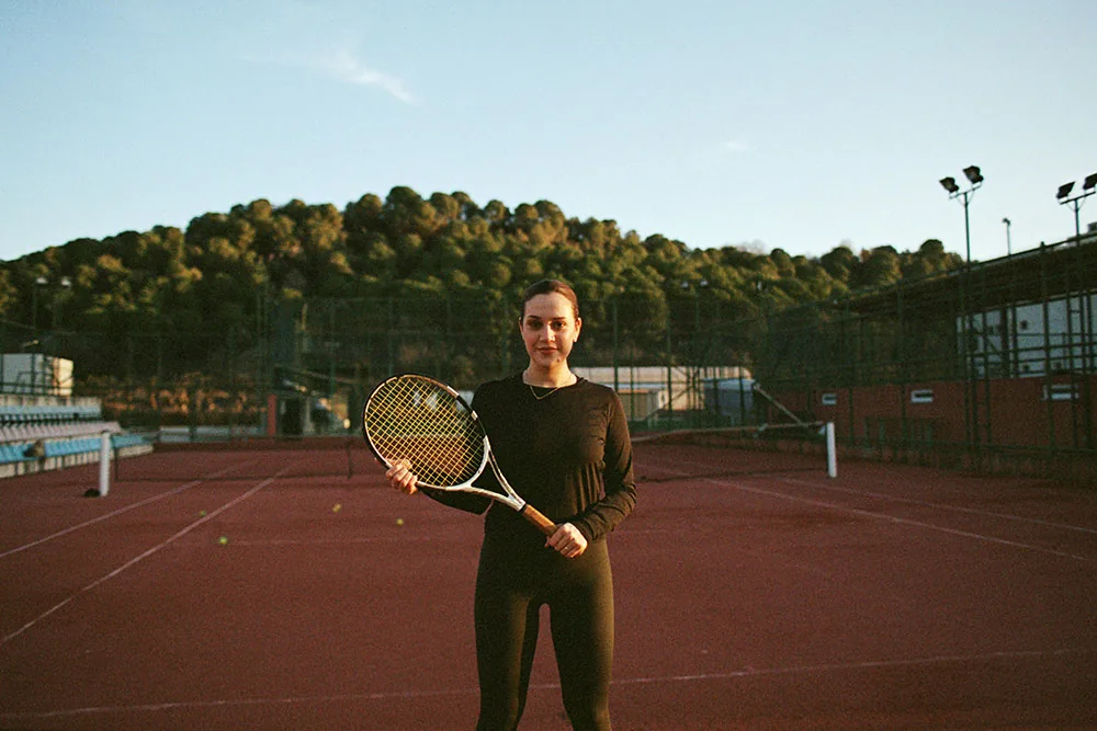 Woman holding a racket on a tennis court